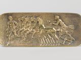 an image of a gold belt buckle with a horse and rider on it