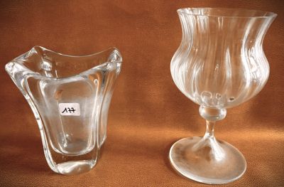 two glass vases sitting next to each other on a table