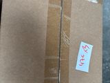 a cardboard box with a sticker on it sitting on the floor
