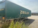 a large green truck that is parked in a parking lot