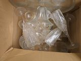 a box full of empty plastic bottles and wine glasses