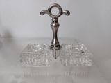 a glass tray with a silver handle on a table