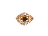 a close up of a gold ring with a black stone in it