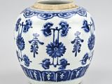 blue and white vase with flowers and vines on a white background