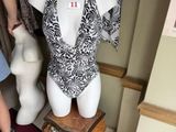 a woman standing next to a mannequin in a store