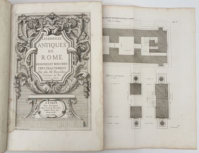 un livre ouvert sur lequel figurent le dessin d'une maison et le plan d'une maison