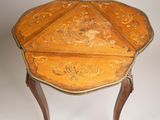 an image of a small wooden table with a carved top