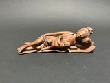 an old figurine of a woman laying down on a mat