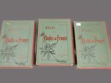 three books are sitting on a table in front of a gray background