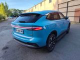 the rear end of a blue suv parked in a parking lot