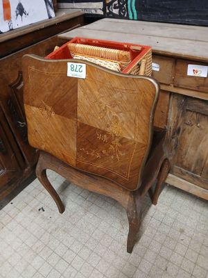 a wooden chair with a basket on top of it