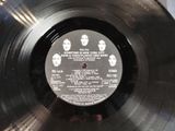 an old record with a picture of the beatles on it ' s side