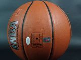 a close up of a basketball ball on a black surface