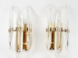 pair of sconces in the shape of glass and brass