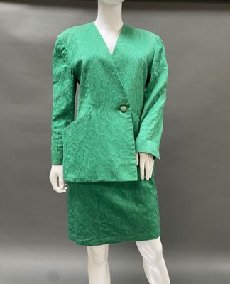 a mannequin wearing a green dress and jacket on a mannequin mannequin mannequin mannequin mannequin mannequin manne