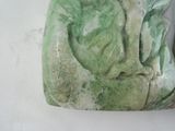 a stone sculpture of a woman with a bird on her shoulder