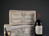 two bottles of wine sitting next to each other on top of a table