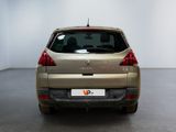 the back of a silver car in a room with a white wall