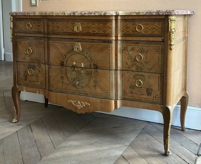 a dresser with a marble top on a herringle floor