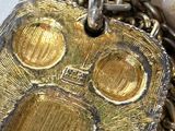 a close up of a metal object on a chain
