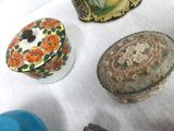 many different types of decorative boxes on the table