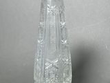 a glass vase on a table with a gray background