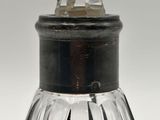 a glass bottle with a crystal top on a table