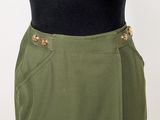 a close up of a woman ' s skirt with buttons on it