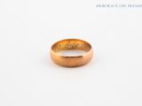a close up of a gold ring with writing on it