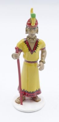 figurine of a man in a yellow outfit with a red staff