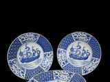 three blue and white plates with a crown on them