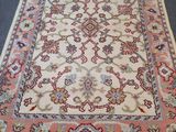an oriental rug with fringes on the floor
