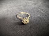 a close up of a silver ring with a flower on it