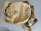 a tan bag with a strap on it on a table