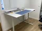 a white desk with a blue top and a black chair in front of it