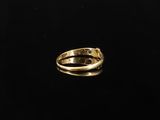 a close up of a gold ring on a black surface