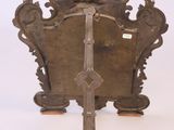 a metal stand with a cross and a crown on it