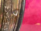 a close up of a pink vase with gold trims