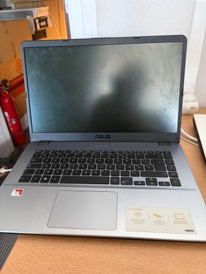 a laptop computer sitting on top of a wooden desk