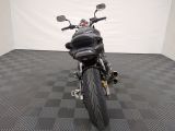 a picture of a black motorcycle parked on a checkered floor