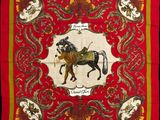 a red banda with a picture of a horse and rider on it