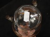 a person holding a glass jar with a label on it
