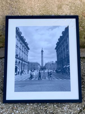 black and white photograph of people crossing a street with a clock tower in the background