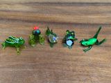 five frogs that are sitting in a row on a table
