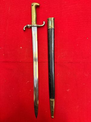 a close up of a sword on a red surface with a red background