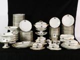 a lot of plates and bowls on a black table