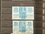 four different colored stamps on a piece of paper in a display case