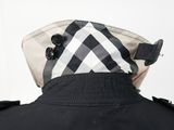 the back of a black jacket with a checkered hat on it