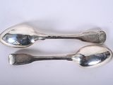 two spoons that are sitting on a table