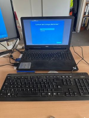 a laptop computer sitting on a desk with a keyboard and mouse